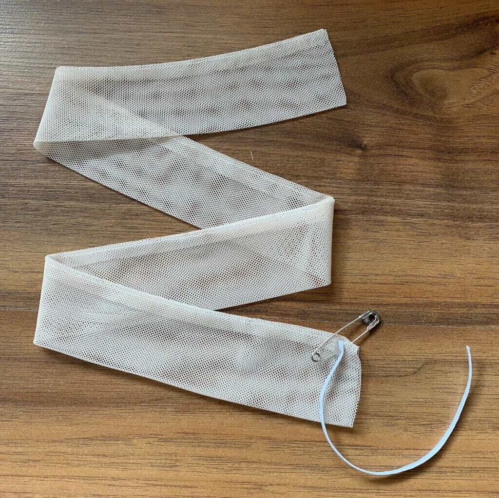 attach safety pin at the end of the tulle tube