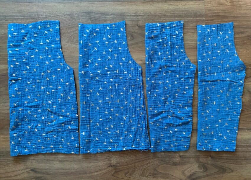 Four pieces of double gauze fabric cut on the fold for a DIY peasant top bodice and sleeves