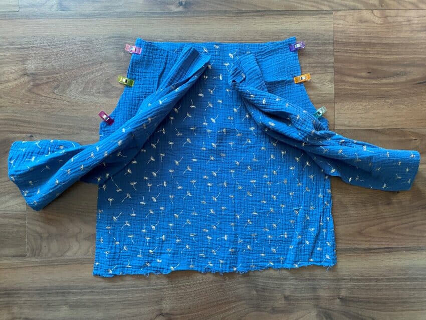 Close-up showing the curved armhole seam where the sleeve meets the bodice of a DIY peasant top