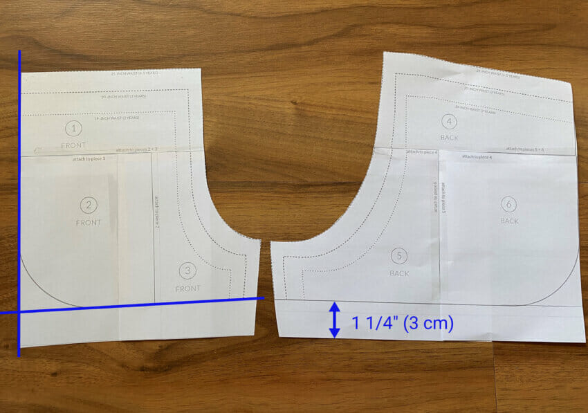 A flat-lay shot of the City Gym Shorts paper pattern being modified to create a straight bottom hemline
