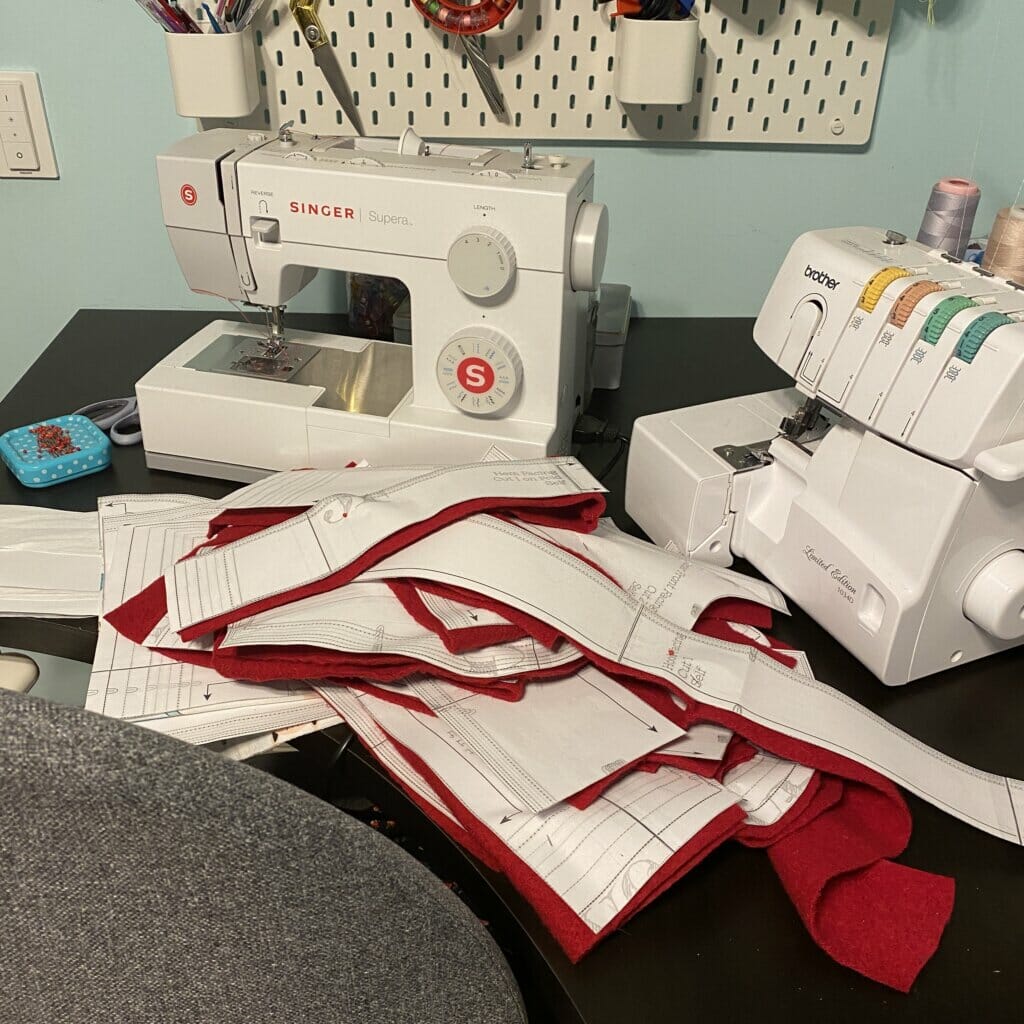 wool coat pattern pieces next to sewing machine