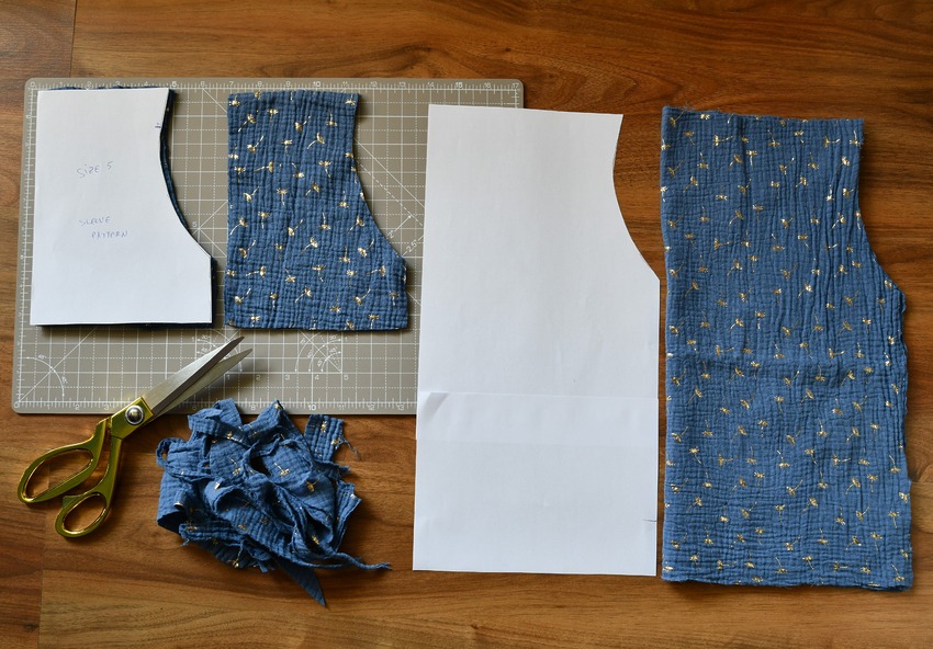 DIY peasant top pattern pieces for a bodice and sleeve laid out on the floor