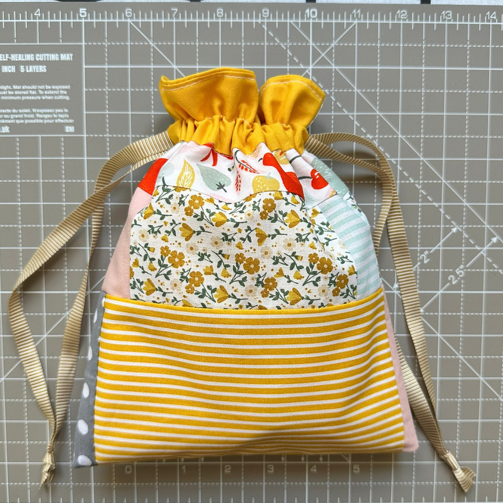 Handmade reusable lined drawstring gift bag tied shut with ribbon