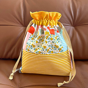 Patchwork lined drawstring gift bag made with floral and striped fabric scraps