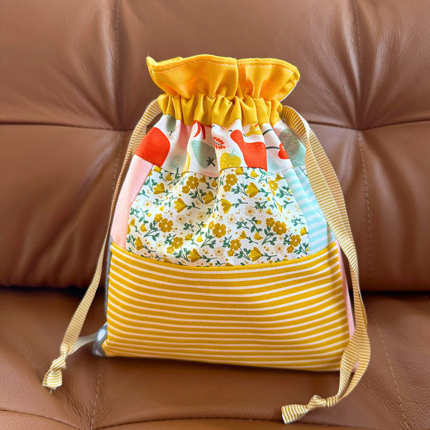 Patchwork lined drawstring gift bag made with floral and striped fabric scraps