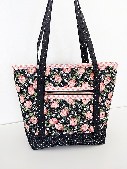 CenterStreetQuilts Fleetwood Tote: A professional-looking quilted tote with a clean geometric stitch pattern, a recessed top zipper, and a front slip pocket featuring a contrast binding finish