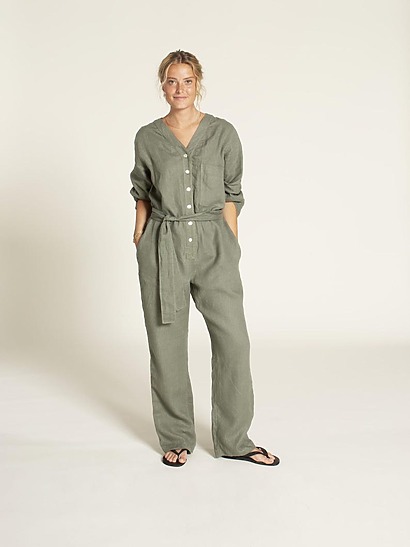 A structured Aviator jumpsuit in medium-weight fabric with a belted waist, button placket, and long sleeves