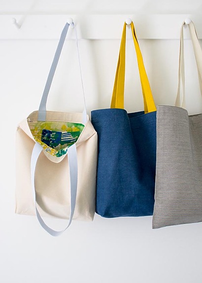 Three different styles of fabric tote bags in colorful prints, showing boxed bottoms and clean French seam finishes