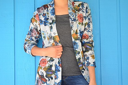 A woman wearing a loose-fit Gilliane cardigan in a soft pastel color with long sleeves