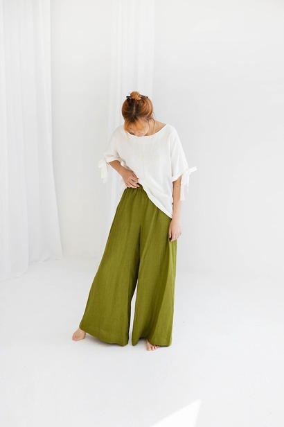 Flowy, extra wide-leg linen palazzo pants in a neutral tone featuring a comfortable elastic waistband and side pockets