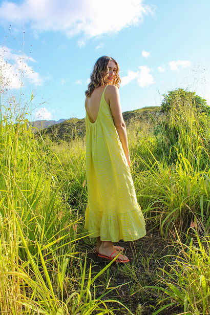 Hallon Dress:

A relaxed backless resort-style sundress showing a dramatic low-cut draped back, a swingy silhouette, and a delicate ruffled bottom hem.