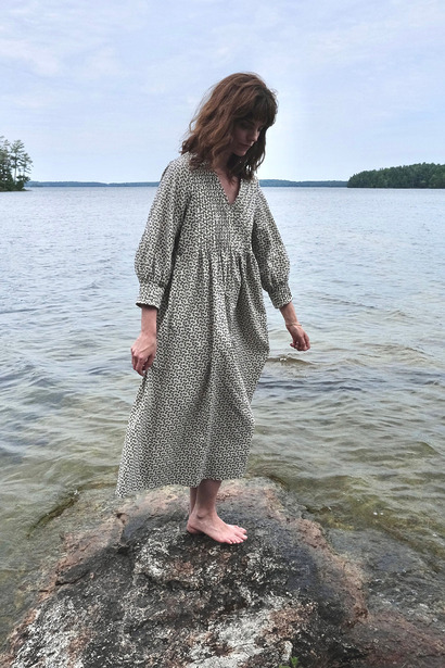 Garden Dress:

A loose-fitting linen midi dress featuring delicate, vintage-inspired pin tuck textures across the front bodice and tailored surrounding cuffs.