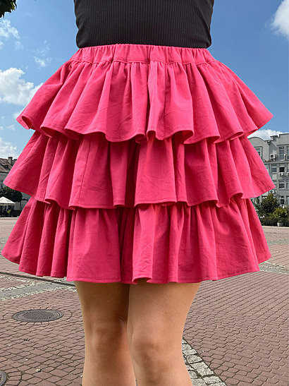 Front facing view of a finished tiered ruffle skirt in pink cotton fabric